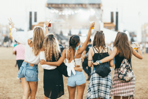 Group of girl friends having fun at a music concert.
